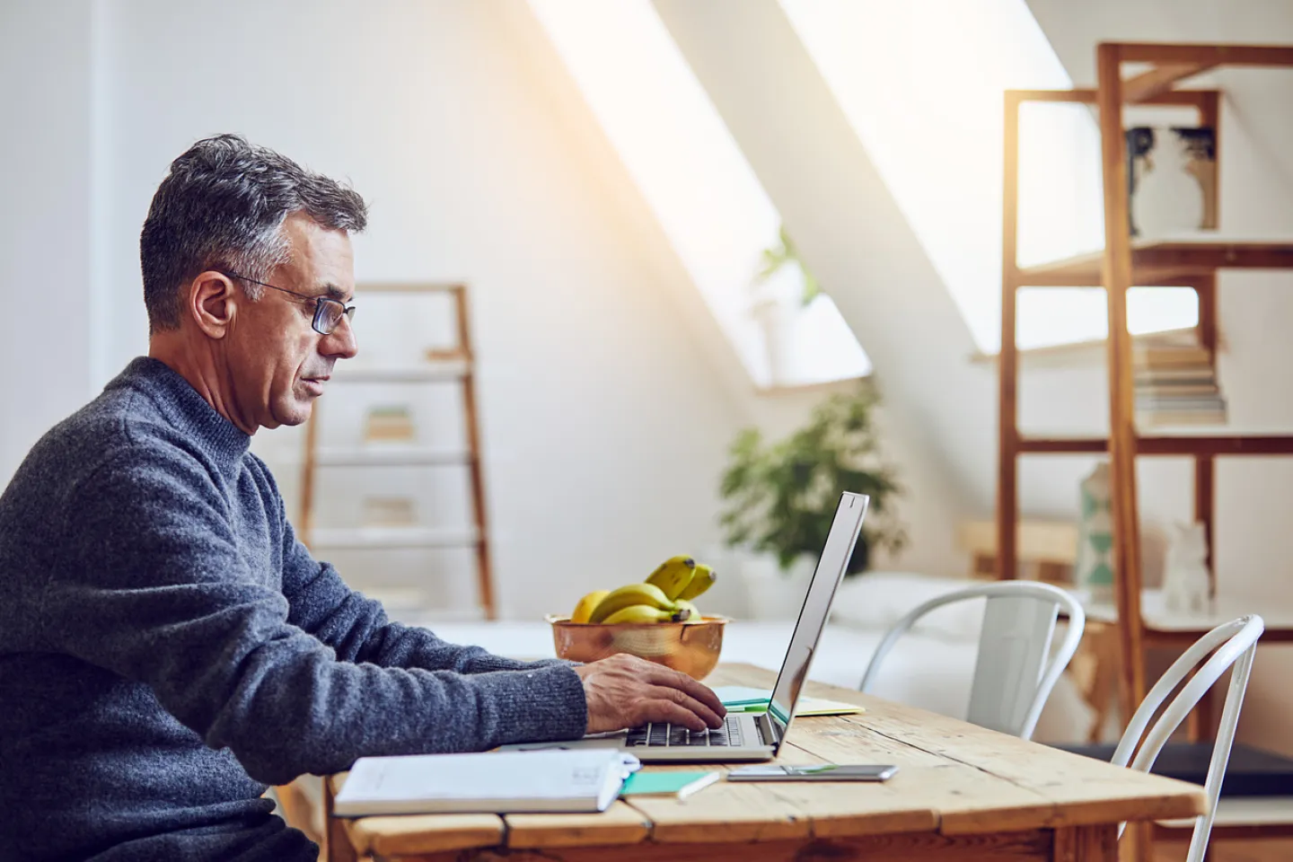 Business man dressed casually on laptop at home