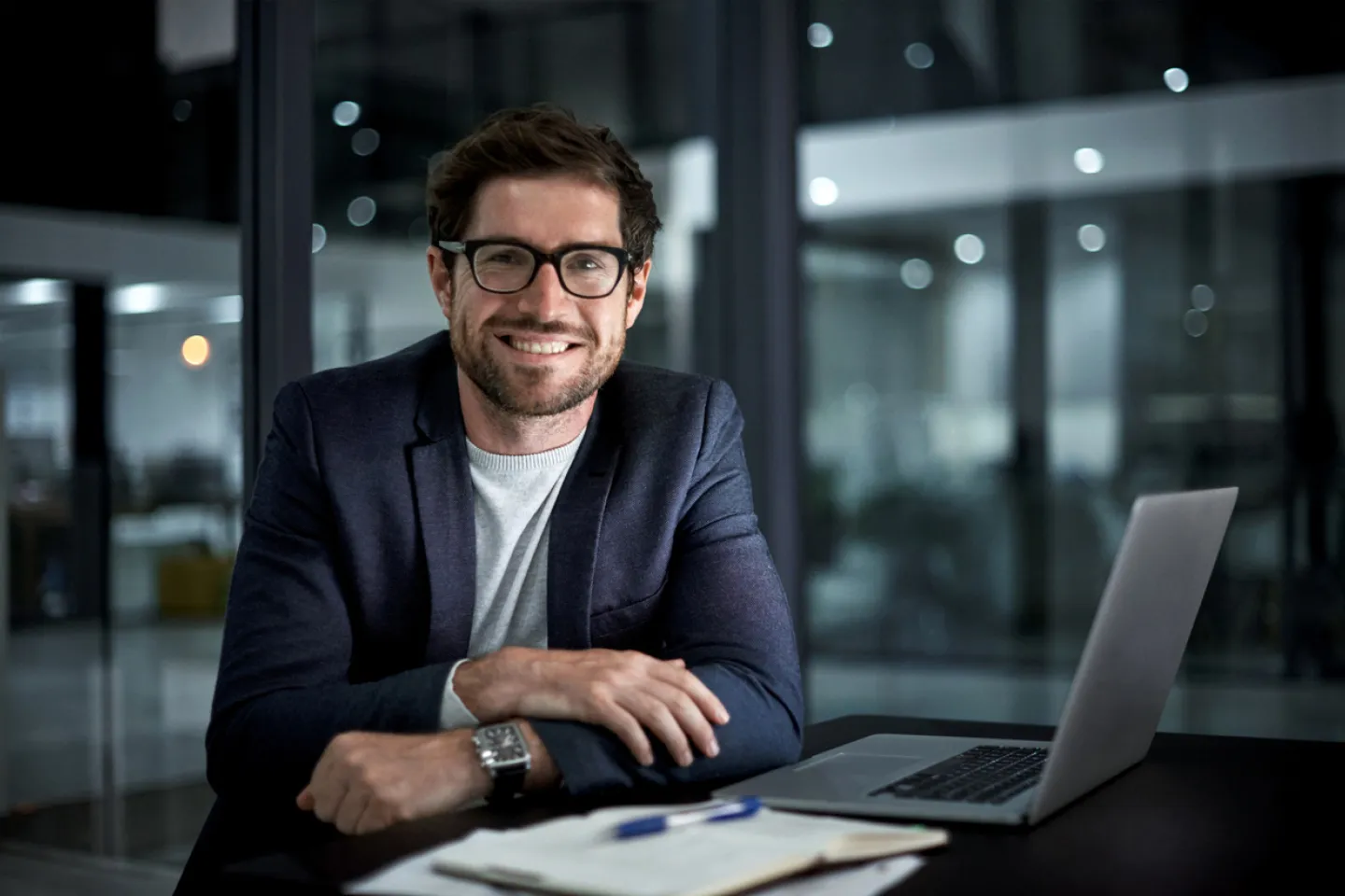 Happy businessman sitting at desk